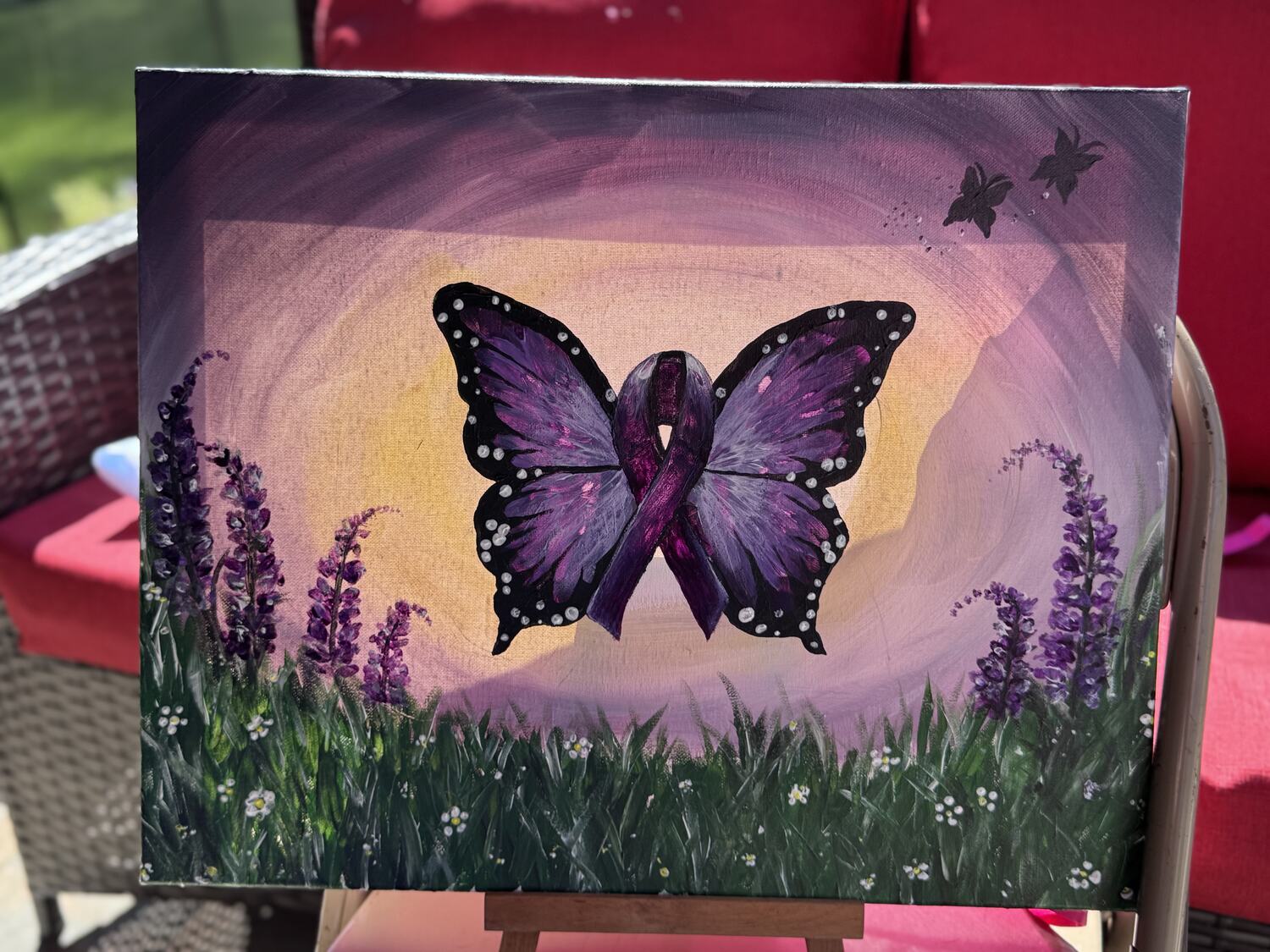 A finished butterfly and ribbon canvas from a fundraiser paint & sip